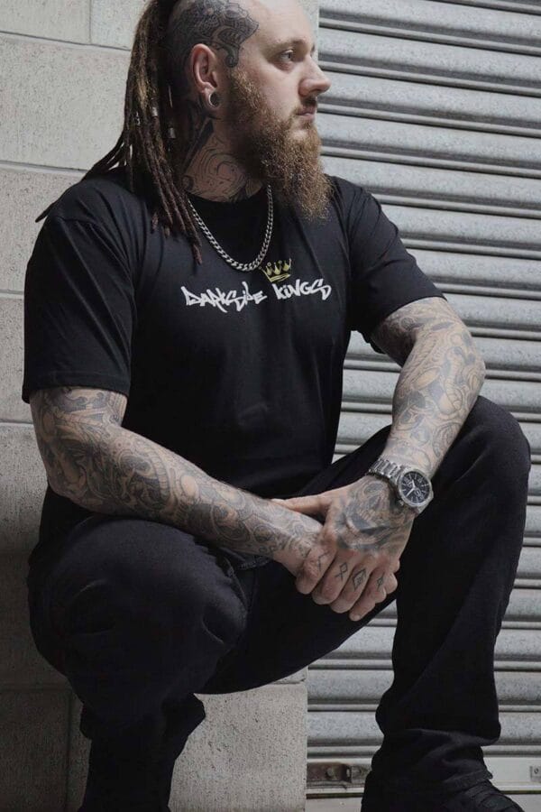 Male wearing a DSK T-shirt while crouching