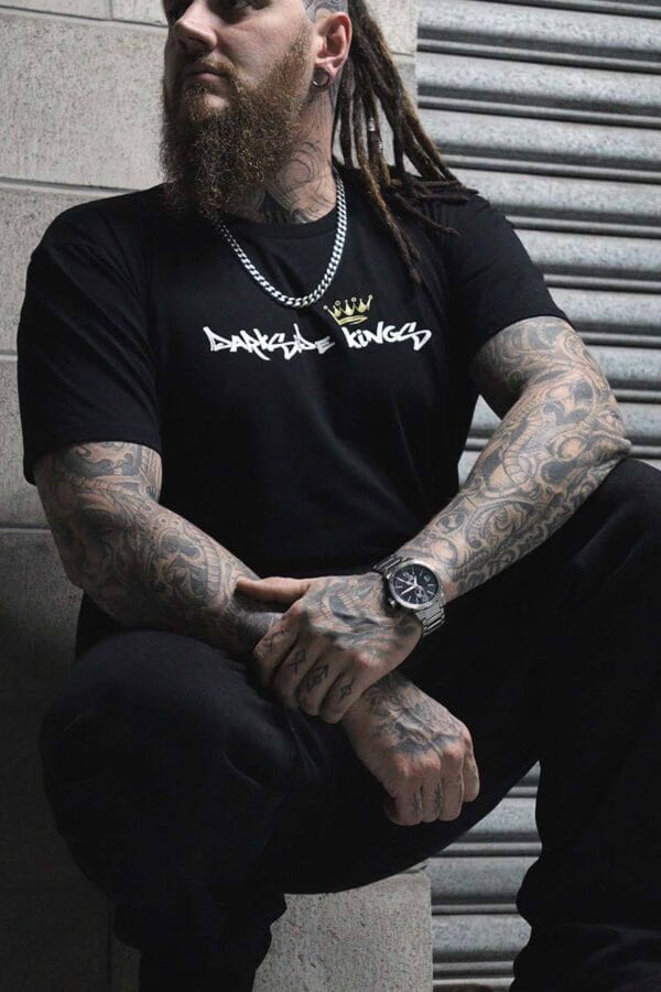 Male wearing a DSK T-shirt while crouching