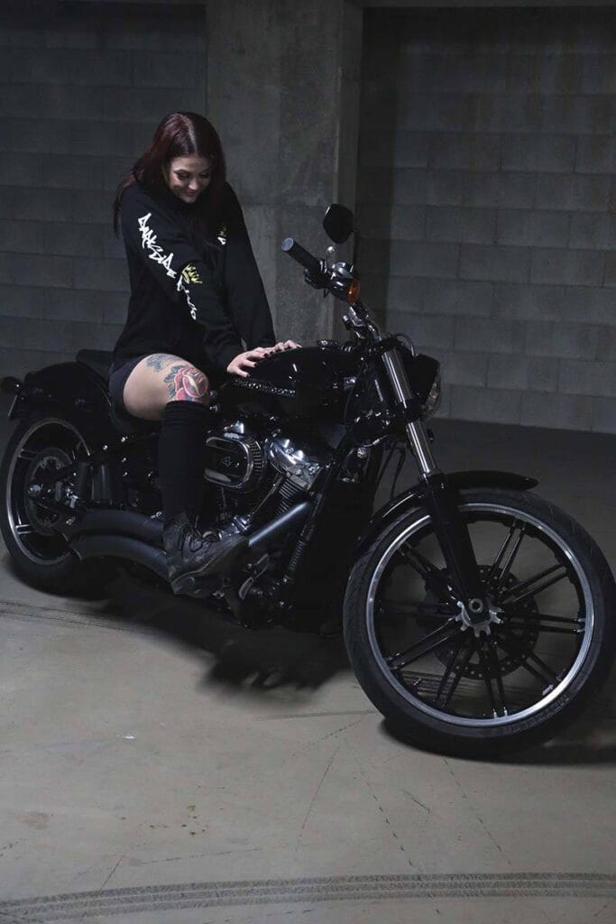 Female sitting on a motorcycle wearing a DSK Hoodie