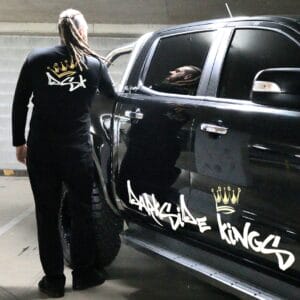 Male wearing a long sleeve DSK shirt standing next to a Ford Ranger