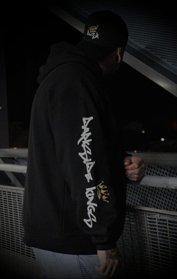 male relaxed hood leaning over railing