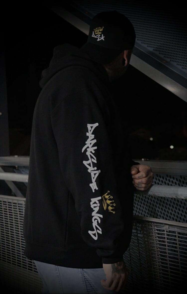 male relaxed hood leaning over railing