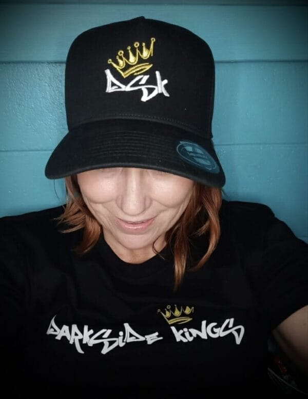 Female wearing a DSK T-shirt and Curved Brim Cap