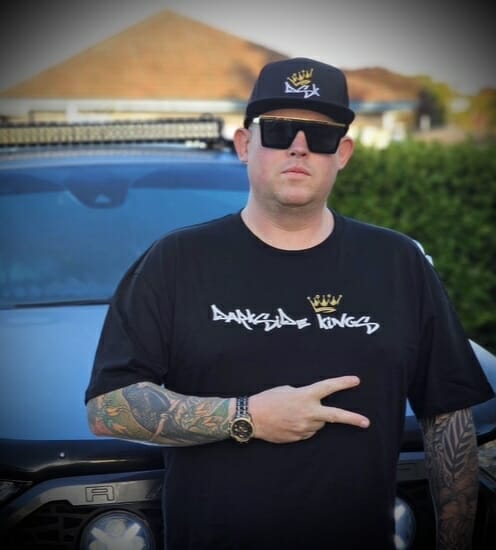 Male wearing a DSK T-shirt and Flat Brim Cap